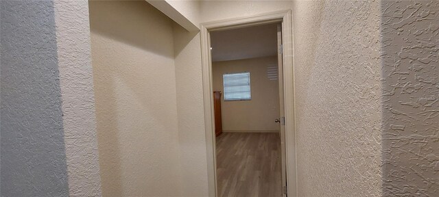 1621 Anniston Ave, Daytona Beach, FL 32117 - hallway with a textured wall, wood finished floors, and baseboards