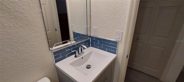 1621 Anniston Ave, Daytona Beach, FL 32117 - half bathroom featuring a textured wall, tile walls, and vanity