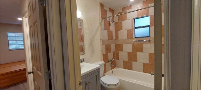 1621 Anniston Ave, Daytona Beach, FL 32117 - bathroom with toilet, a textured wall, vanity, and bathtub / shower combination