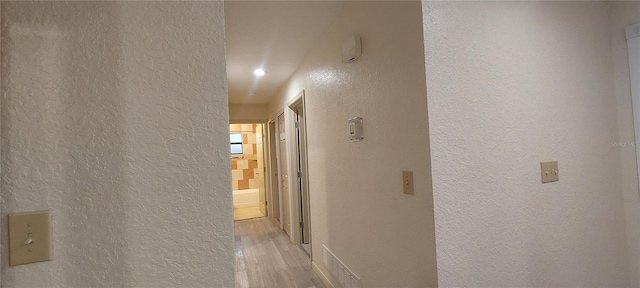 1621 Anniston Ave, Daytona Beach, FL 32117 - corridor with a textured wall and light wood-style flooring