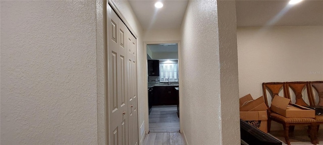 1621 Anniston Ave, Daytona Beach, FL 32117 - hall featuring a textured wall, a sink, and wood finished floors