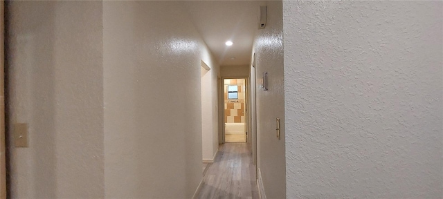 1621 Anniston Ave, Daytona Beach, FL 32117 - hallway featuring a textured wall, wood finished floors, recessed lighting, and baseboards