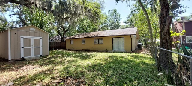 1621 Anniston Ave, Daytona Beach, FL 32117 - rear view of property featuring a storage unit, an outbuilding, and central air condition unit