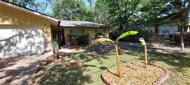 1621 Anniston Ave, Daytona Beach, FL 32117 - view of yard featuring fence, driveway, and a garage