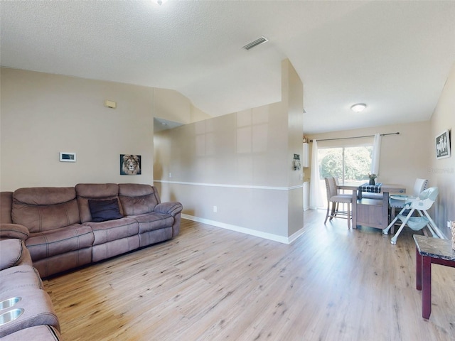2978 Greynolds St, Deltona, FL 32738 - living room featuring light wood-type flooring, vaulted ceiling, and baseboards