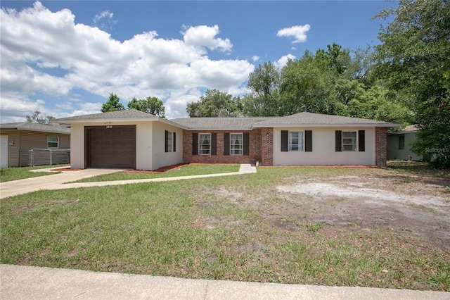 2842 English Dr, Deltona, FL 32738 - ranch-style house featuring an attached garage, concrete driveway, a front yard, brick siding, and stucco siding