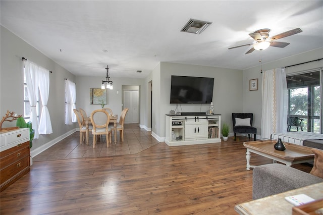 2842 English Dr, Deltona, FL 32738 - living area with ceiling fan, baseboards, hardwood / wood-style flooring, and a chandelier