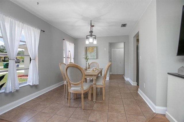 2842 English Dr, Deltona, FL 32738 - dining room featuring light tile patterned flooring, baseboards, and a chandelier