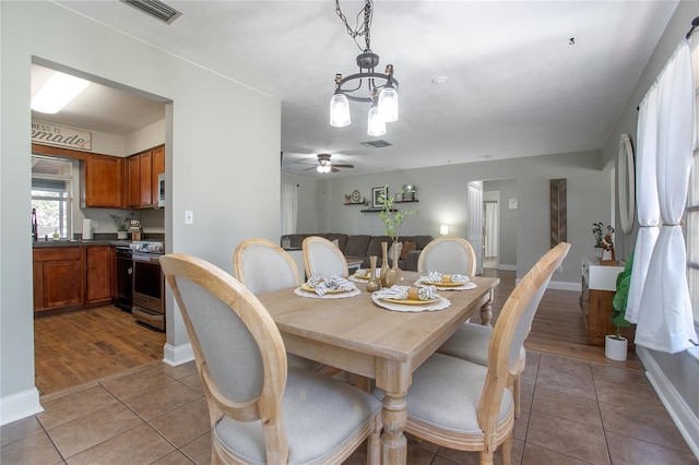 2842 English Dr, Deltona, FL 32738 - dining area featuring a chandelier, tile patterned floors, and baseboards