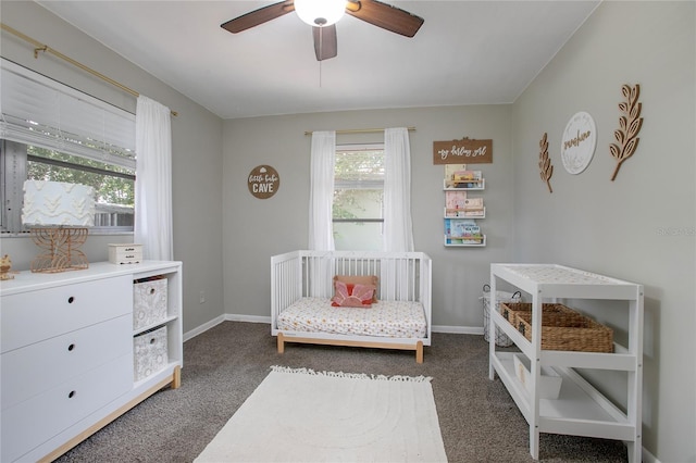 2842 English Dr, Deltona, FL 32738 - carpeted bedroom featuring a nursery area, baseboards, and ceiling fan