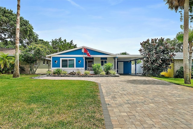 809 E 14th Ave, New Smyrna Beach, FL 32169 - ranch-style home featuring decorative driveway, a front yard, and an attached carport