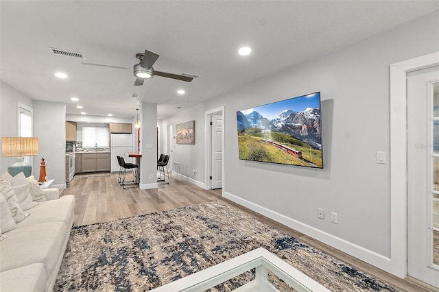 809 E 14th Ave, New Smyrna Beach, FL 32169 - living area featuring light wood-style flooring, recessed lighting, a ceiling fan, and baseboards