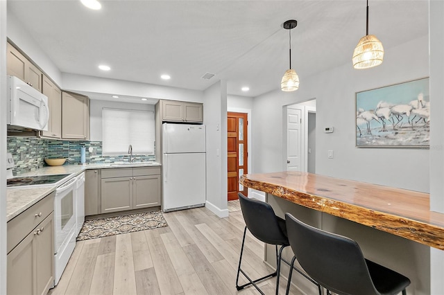 809 E 14th Ave, New Smyrna Beach, FL 32169 - kitchen with white appliances, gray cabinets, a sink, light wood-type flooring, and recessed lighting