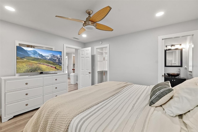 809 E 14th Ave, New Smyrna Beach, FL 32169 - bedroom featuring light wood finished floors, recessed lighting, connected bathroom, and a ceiling fan
