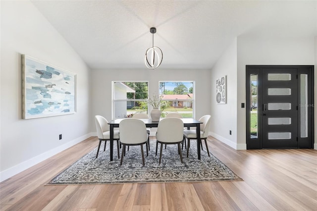23 Forest Hill Dr, Palm Coast, FL 32137 - dining area featuring wood finished floors, baseboards, and vaulted ceiling