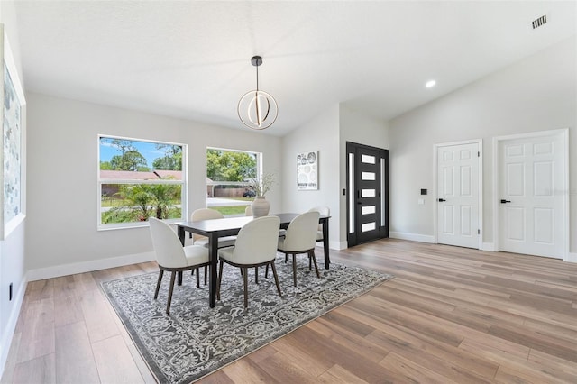 23 Forest Hill Dr, Palm Coast, FL 32137 - dining room with light wood-type flooring, baseboards, and high vaulted ceiling
