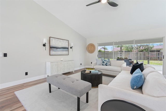 23 Forest Hill Dr, Palm Coast, FL 32137 - living area featuring a ceiling fan, baseboards, high vaulted ceiling, and light wood-style flooring