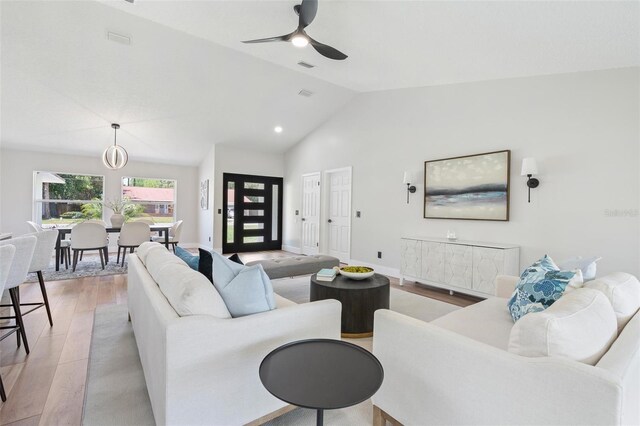 23 Forest Hill Dr, Palm Coast, FL 32137 - living room featuring light wood finished floors, vaulted ceiling, ceiling fan, and baseboards
