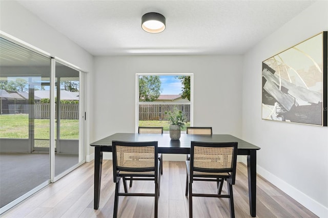 23 Forest Hill Dr, Palm Coast, FL 32137 - dining space with light wood-style flooring and baseboards