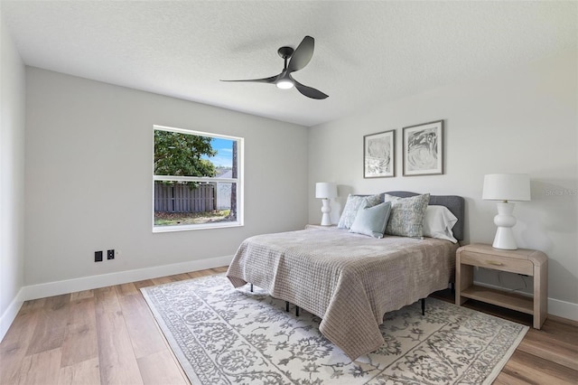 23 Forest Hill Dr, Palm Coast, FL 32137 - bedroom featuring baseboards, wood finished floors, a textured ceiling, and ceiling fan