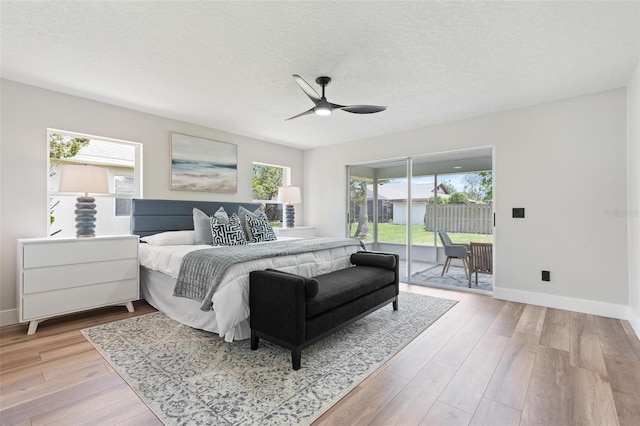 23 Forest Hill Dr, Palm Coast, FL 32137 - bedroom featuring access to outside, light wood finished floors, baseboards, a textured ceiling, and ceiling fan