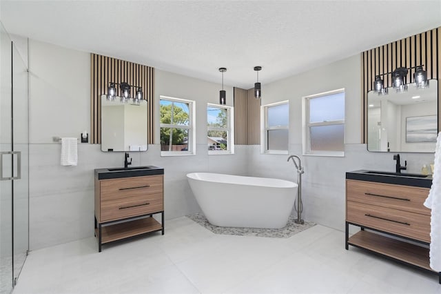 23 Forest Hill Dr, Palm Coast, FL 32137 - bathroom featuring two vanities, a soaking tub, a shower stall, and tile walls