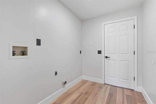 23 Forest Hill Dr, Palm Coast, FL 32137 - laundry room with hookup for an electric dryer, light wood-style flooring, baseboards, and hookup for a washing machine