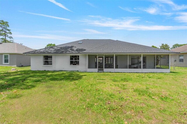 23 Forest Hill Dr, Palm Coast, FL 32137 - rear view of property featuring a sunroom, a yard, and stucco siding