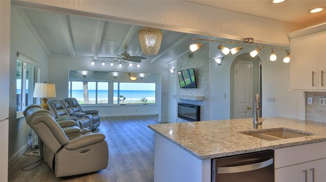 8 Ocean Dunes Dr, Ormond Beach, FL 32176 - kitchen featuring dishwasher, a sink, a ceiling fan, arched walkways, and beam ceiling