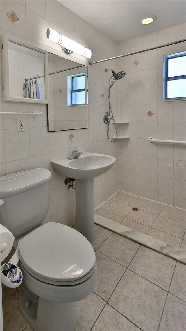 8 Ocean Dunes Dr, Ormond Beach, FL 32176 - full bath with tile walls, tiled shower, toilet, and tile patterned floors