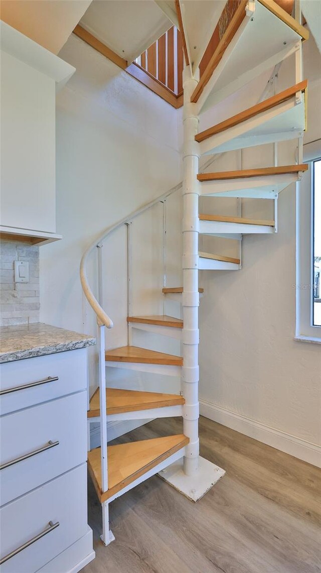 8 Ocean Dunes Dr, Ormond Beach, FL 32176 - stairs featuring baseboards and wood finished floors