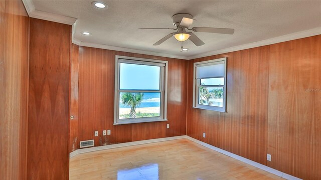 8 Ocean Dunes Dr, Ormond Beach, FL 32176 - unfurnished room featuring wood finished floors, ornamental molding, a textured ceiling, a ceiling fan, and baseboards