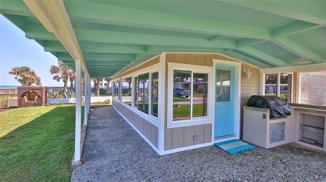 8 Ocean Dunes Dr, Ormond Beach, FL 32176 - view of patio featuring a brick fireplace, exterior kitchen, and grilling area