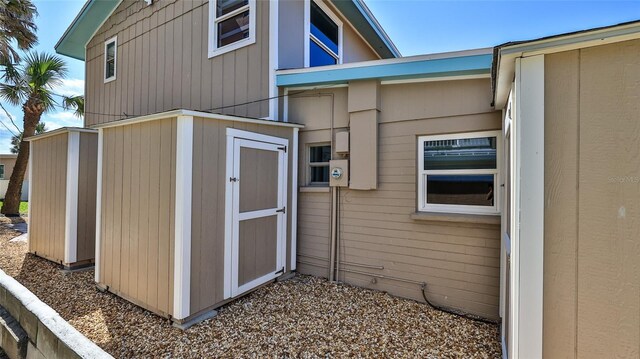 8 Ocean Dunes Dr, Ormond Beach, FL 32176 - view of side of home with a storage unit and an outdoor structure