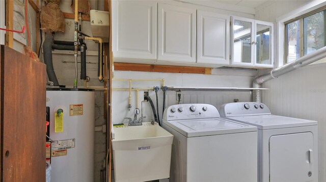 8 Ocean Dunes Dr, Ormond Beach, FL 32176 - laundry room with water heater, washer and clothes dryer, and cabinet space