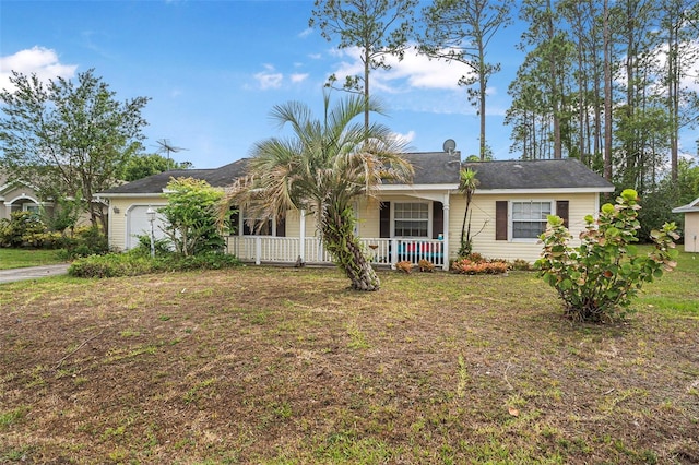 single story home with a porch, a garage, and a front yard