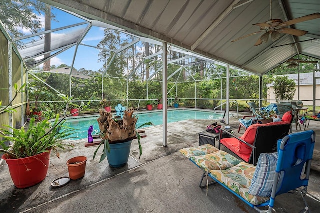 swimming pool with a ceiling fan, a patio, and a lanai