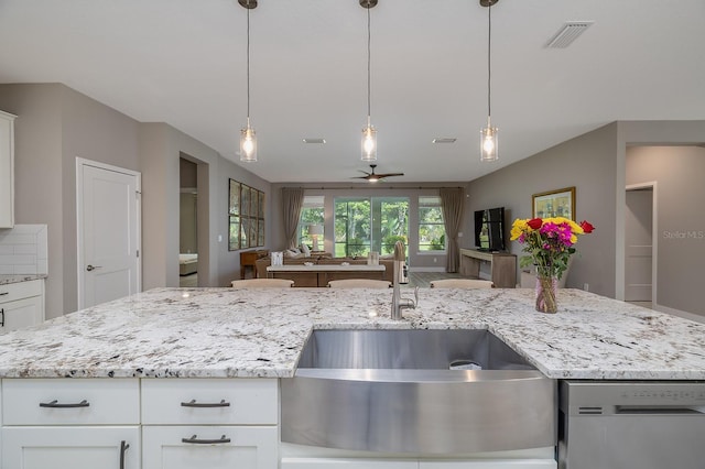 3026 Adrian Dr, Ormond Beach, FL 32174 - kitchen featuring a sink, open floor plan, ceiling fan, stainless steel dishwasher, and light stone countertops