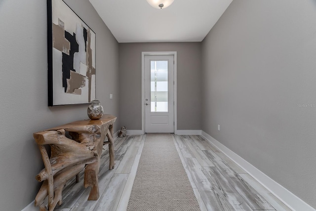 3026 Adrian Dr, Ormond Beach, FL 32174 - doorway with light wood-type flooring and baseboards