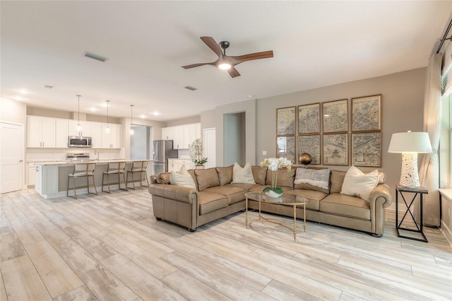 3026 Adrian Dr, Ormond Beach, FL 32174 - living room with ceiling fan, light wood-style flooring, and baseboards