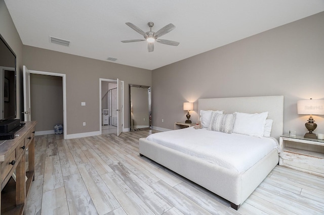 3026 Adrian Dr, Ormond Beach, FL 32174 - bedroom with light wood-type flooring, baseboards, a ceiling fan, and connected bathroom