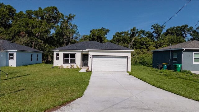 248 S Virginia Ave, Deland, FL 32724 - view of front facade featuring an attached garage, a front lawn, concrete driveway, and stucco siding