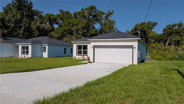 248 S Virginia Ave, Deland, FL 32724 - single story home featuring central AC, concrete driveway, a front yard, an attached garage, and stucco siding