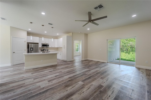 248 S Virginia Ave, Deland, FL 32724 - unfurnished living room with light wood-style flooring, a ceiling fan, recessed lighting, and baseboards