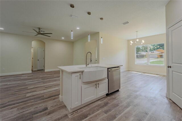 248 S Virginia Ave, Deland, FL 32724 - kitchen with dishwasher, a sink, open floor plan, wood finished floors, and a kitchen island with sink