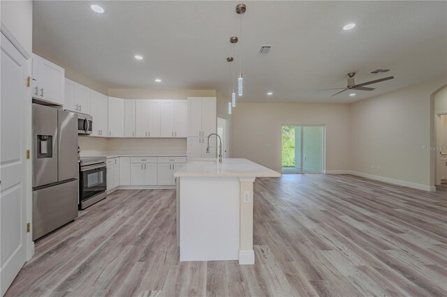 248 S Virginia Ave, Deland, FL 32724 - kitchen featuring stainless steel appliances, a ceiling fan, light countertops, light wood-type flooring, and recessed lighting