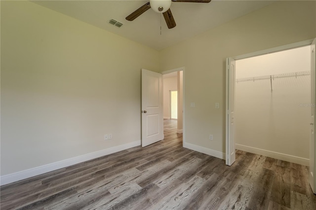 248 S Virginia Ave, Deland, FL 32724 - unfurnished bedroom with wood finished floors, a closet, baseboards, and a ceiling fan