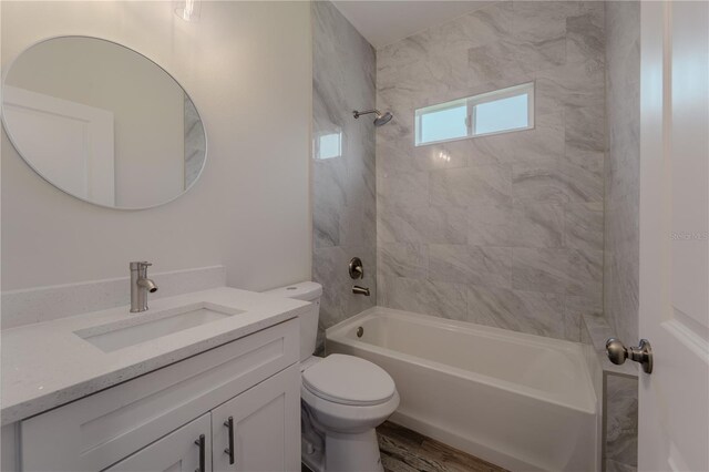 248 S Virginia Ave, Deland, FL 32724 - full bathroom with toilet, vanity, shower / tub combination, and wood finished floors