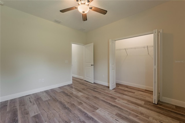 248 S Virginia Ave, Deland, FL 32724 - unfurnished bedroom with wood finished floors, a closet, baseboards, and ceiling fan