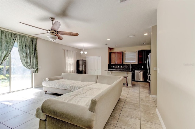 12079 Alder Branch Loop, Orlando, FL 32824 - living room featuring light tile patterned flooring, a ceiling fan, recessed lighting, baseboards, and a chandelier
